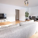 Helles Wohnzimmer der Ferienwohnung in Bamberg für bis zu 6 Personen mit großem Essbereich und direktem Zugang zum Balkon. Ideal für Familien und Gruppen nahe der Bamberger Altstadt.